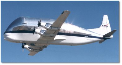 The image shows a NASA aircraft in flight against a clear blue sky. The aircraft has a distinctive, bulbous front section and a sleek, reflective silver body with a dark stripe running along the side. The NASA logo is visible on the tail of the plane.