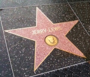 The image shows a star on the Hollywood Walk of Fame with the name "Jerry Lewis" inscribed on it. The star is set in a terrazzo and brass square embedded in the sidewalk.