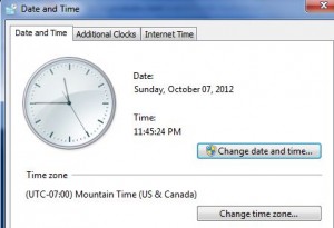 The image shows a "Date and Time" settings window from a computer. The window displays the current date as Sunday, October 07, 2012, and the time as 11:45:24 PM. There is an analog clock on the left side showing the same time. Below the date and time, the time zone is listed as (UTC-07:00) Mountain Time (US & Canada). There are buttons labeled "Change date and time..." and "Change time zone...". The window also has tabs for "Date and Time," "Additional Clocks," and "Internet Time."