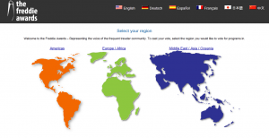 Alt text: The image shows a webpage for the Freddie Awards, featuring a world map divided into three regions: Americas (in orange), Europe/Africa (in green), and Middle East/Asia/Oceania (in blue). At the top, there are language options including English, German, Spanish, French, Japanese, and Chinese. The text invites users to select their region to vote for programs in the Freddie Awards.